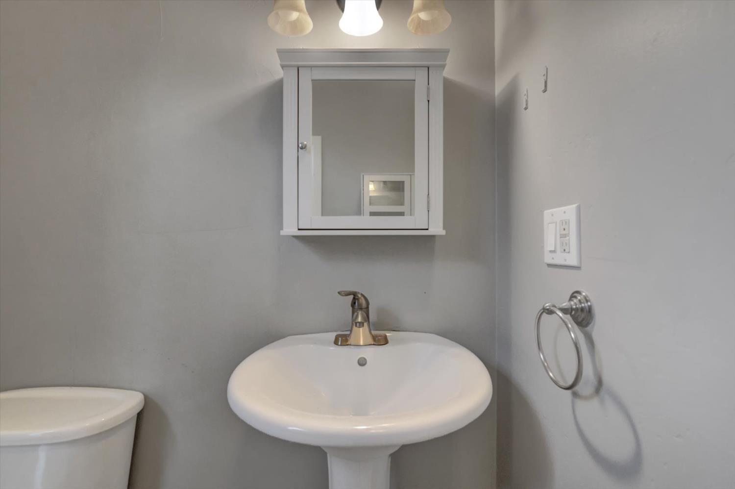 618 Walsh Street Grass Valley, CA 95945 - Photo 16 of 32 a bathroom with a toilet sink and mirror