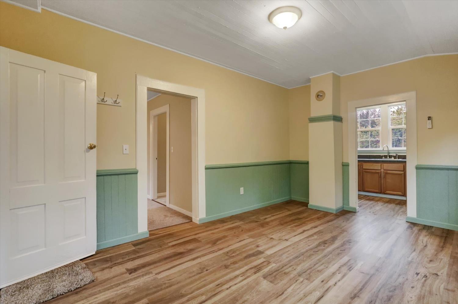 618 Walsh Street Grass Valley, CA 95945 - Photo 6 of 32 wooden floor in an empty room with kitchen