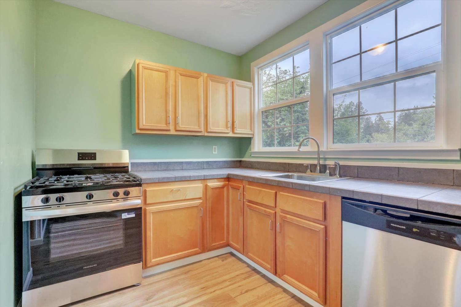 618 Walsh Street Grass Valley, CA 95945 - Photo 7 of 32 a kitchen with a stove a sink and a window