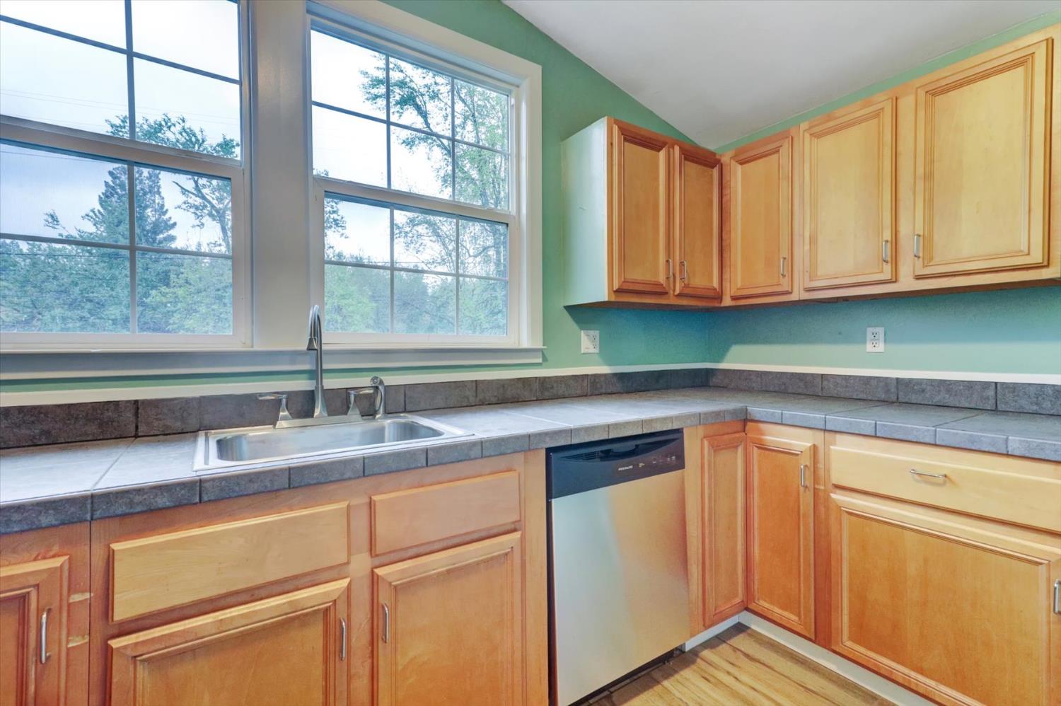 618 Walsh Street Grass Valley, CA 95945 - Photo 9 of 32 a kitchen with granite countertop cabinets sink and window