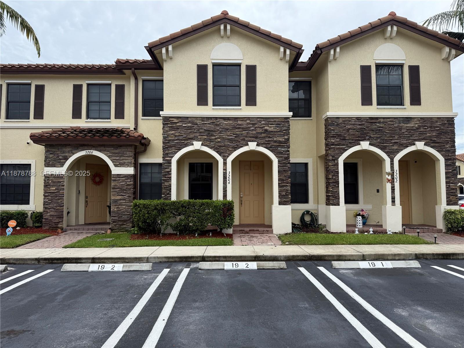 3204 Southeast 5th Court Homestead, FL 33033 - Photo 1 of 25 a front view of a house with garden