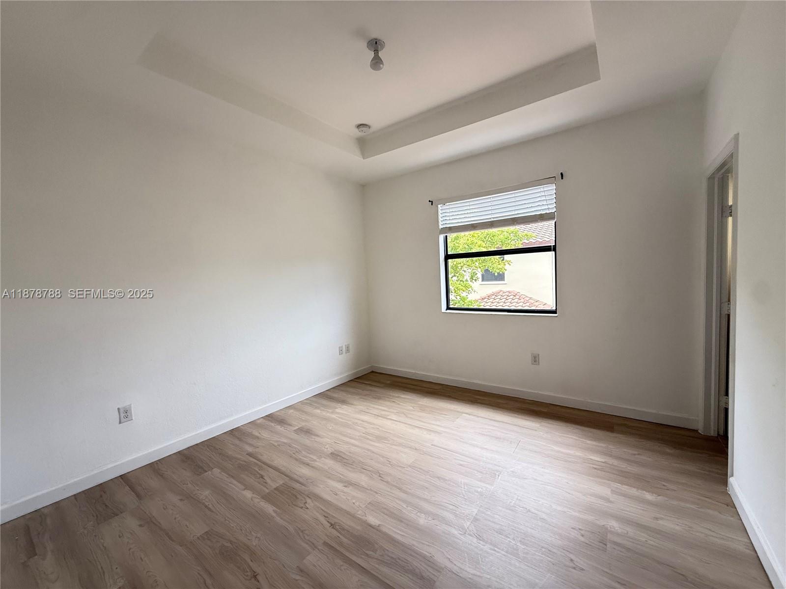3204 Southeast 5th Court Homestead, FL 33033 - Photo 11 of 25 wooden floor in an empty room with a window