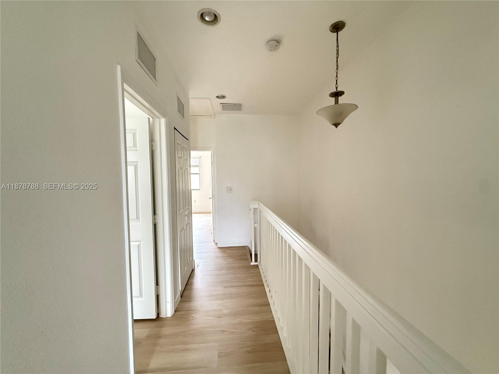 3204 Southeast 5th Court Homestead, FL 33033 - Photo 20 of 25 a view of a hallway with a wooden floor