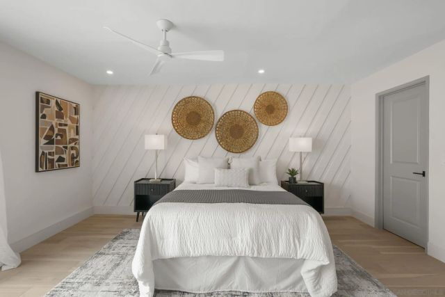 a bedroom with bed and a chandelier