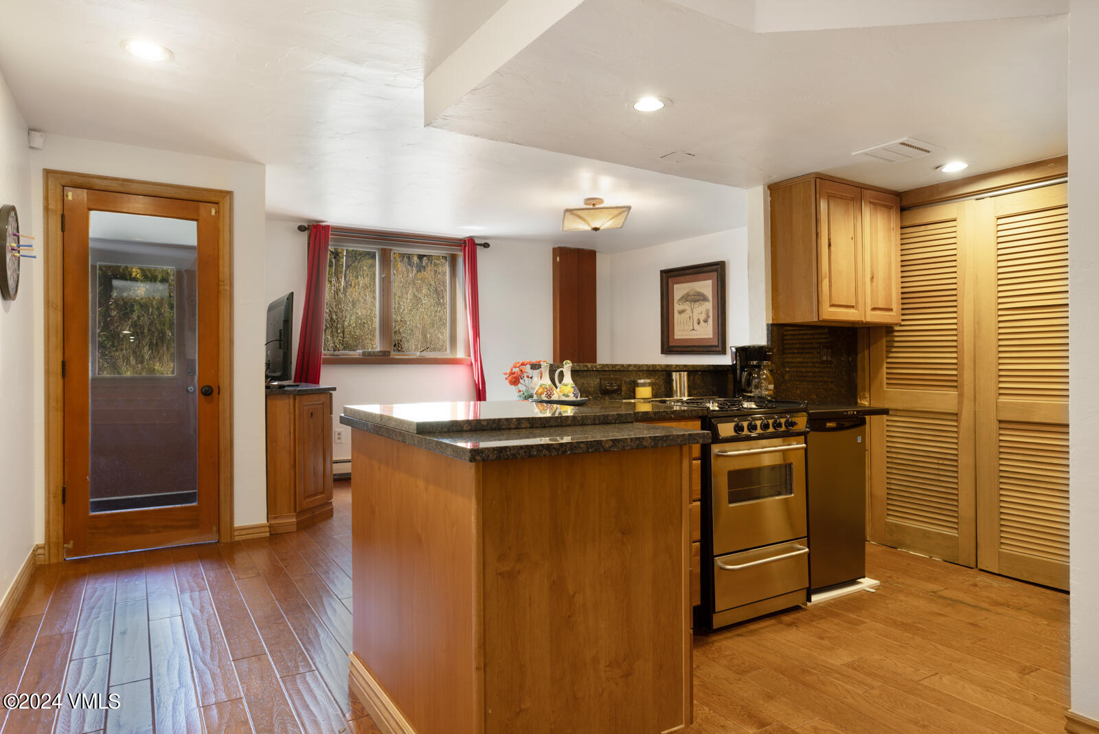 2701 Davos Trail Vail, CO 81657 - Photo 28 of 29 a kitchen with stainless steel appliances granite countertop a stove refrigerator and cabinets