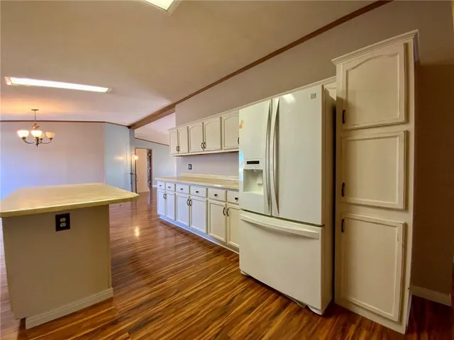 a kitchen with stainless steel appliances a refrigerator and a stove top oven