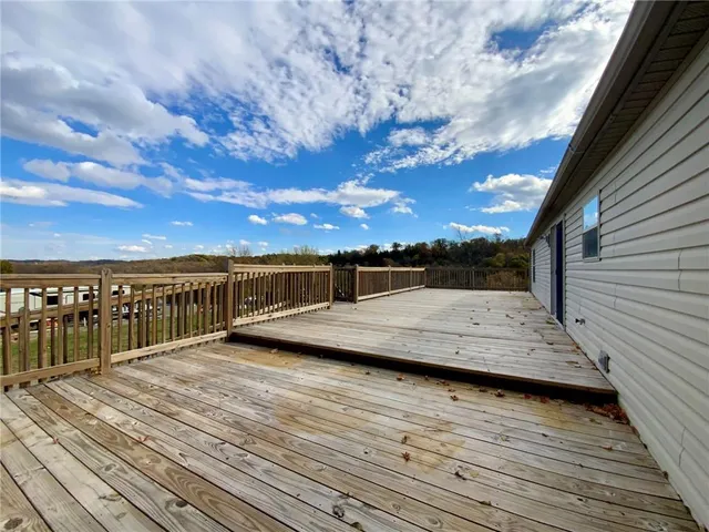 a view of a balcony with wooden floor and city view