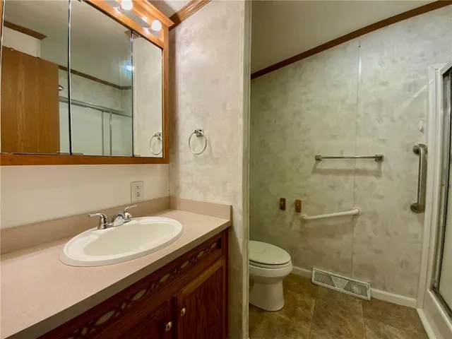 a bathroom with a sink toilet and shower