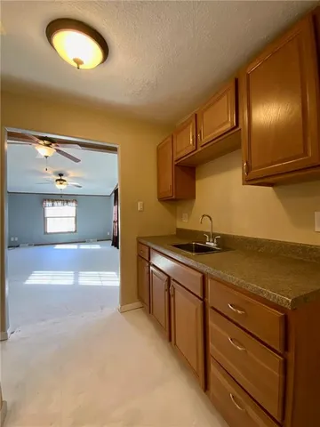 a view of a kitchen with a sink cabinets and a window