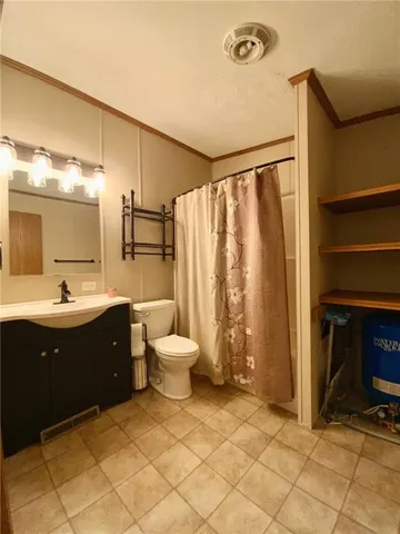 a spacious bathroom with a double vanity sink and a mirror
