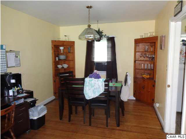 249 Shamrock Road, Unit A & B Charlottesville, VA 22903 - Photo 4 of 6 a dining room with furniture a chandelier and wooden floor