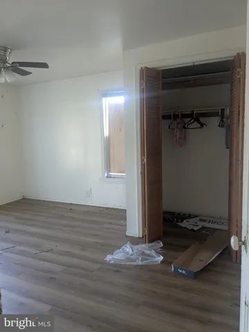 a view of a hallway with wooden floor and entryway