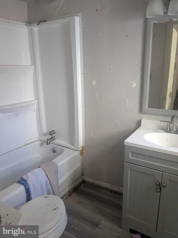 an empty room with wooden floor and a window