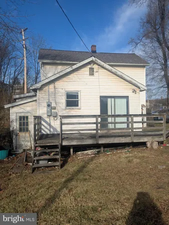 a view of a house with a wooden deck