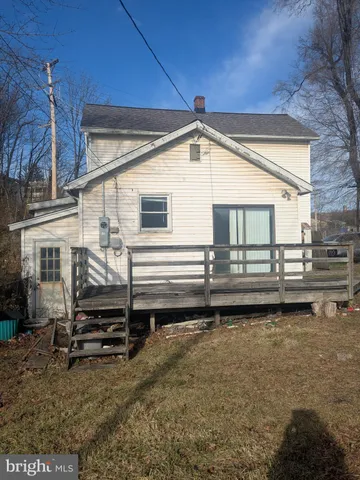 a view of a house with a wooden deck