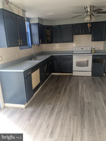 a kitchen with stainless steel appliances granite countertop a sink and a stove top oven