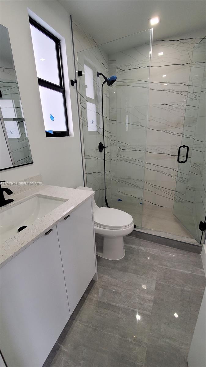 40 Southwest 34th Avenue, Unit C Miami, FL 33135 - Photo 11 of 24 a bathroom with a sink a toilet and shower