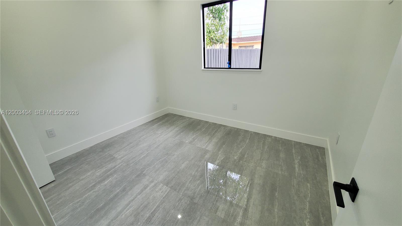 40 Southwest 34th Avenue, Unit C Miami, FL 33135 - Photo 12 of 24 an empty room with a window