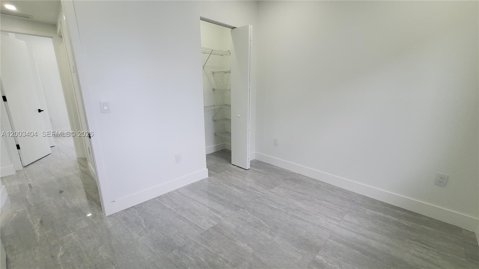 40 Southwest 34th Avenue, Unit C Miami, FL 33135 - Photo 13 of 24 an empty room with wooden floor