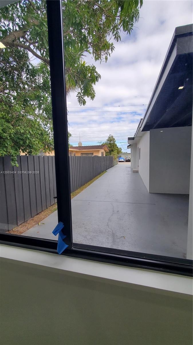 40 Southwest 34th Avenue, Unit C Miami, FL 33135 - Photo 15 of 24 a view of balcony with wooden floor and fence