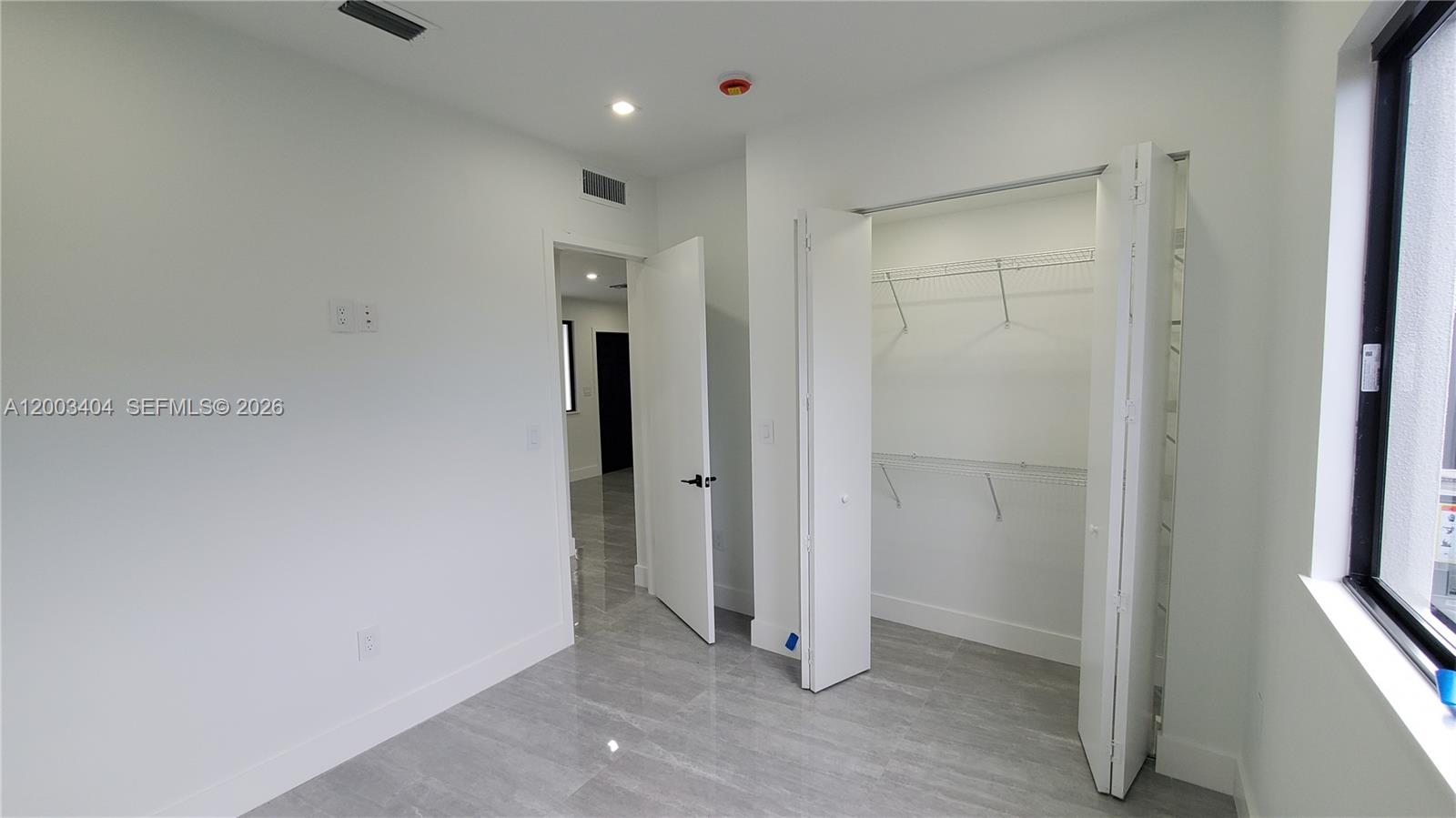 40 Southwest 34th Avenue, Unit C Miami, FL 33135 - Photo 21 of 24 an empty room with windows