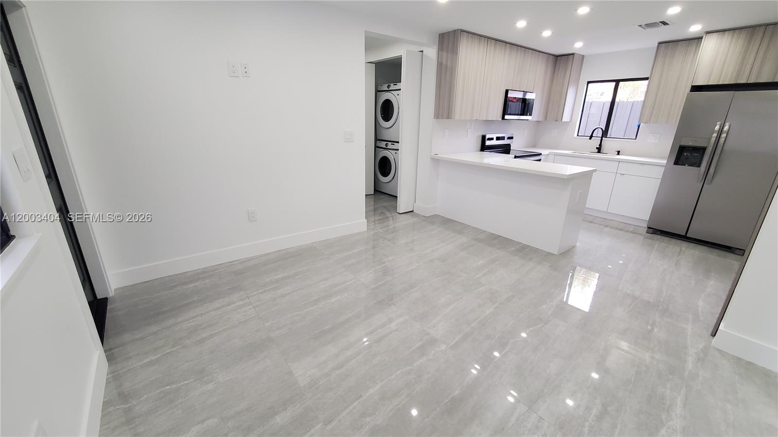 40 Southwest 34th Avenue, Unit C Miami, FL 33135 - Photo 4 of 24 a kitchen with stainless steel appliances a refrigerator sink and microwave