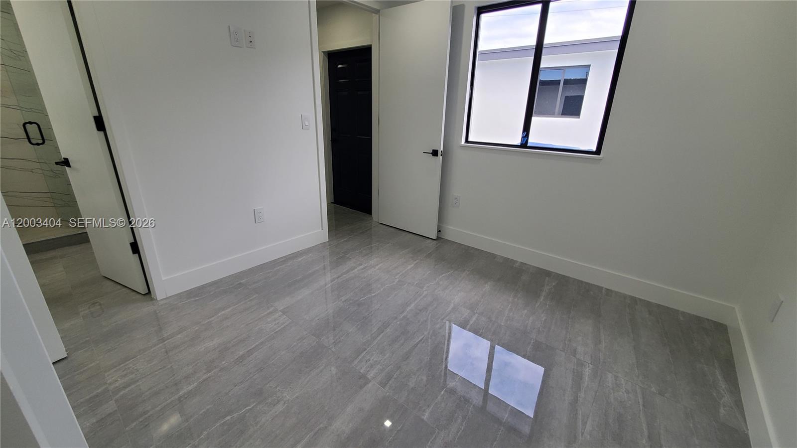 40 Southwest 34th Avenue, Unit C Miami, FL 33135 - Photo 10 of 24 an empty room with windows