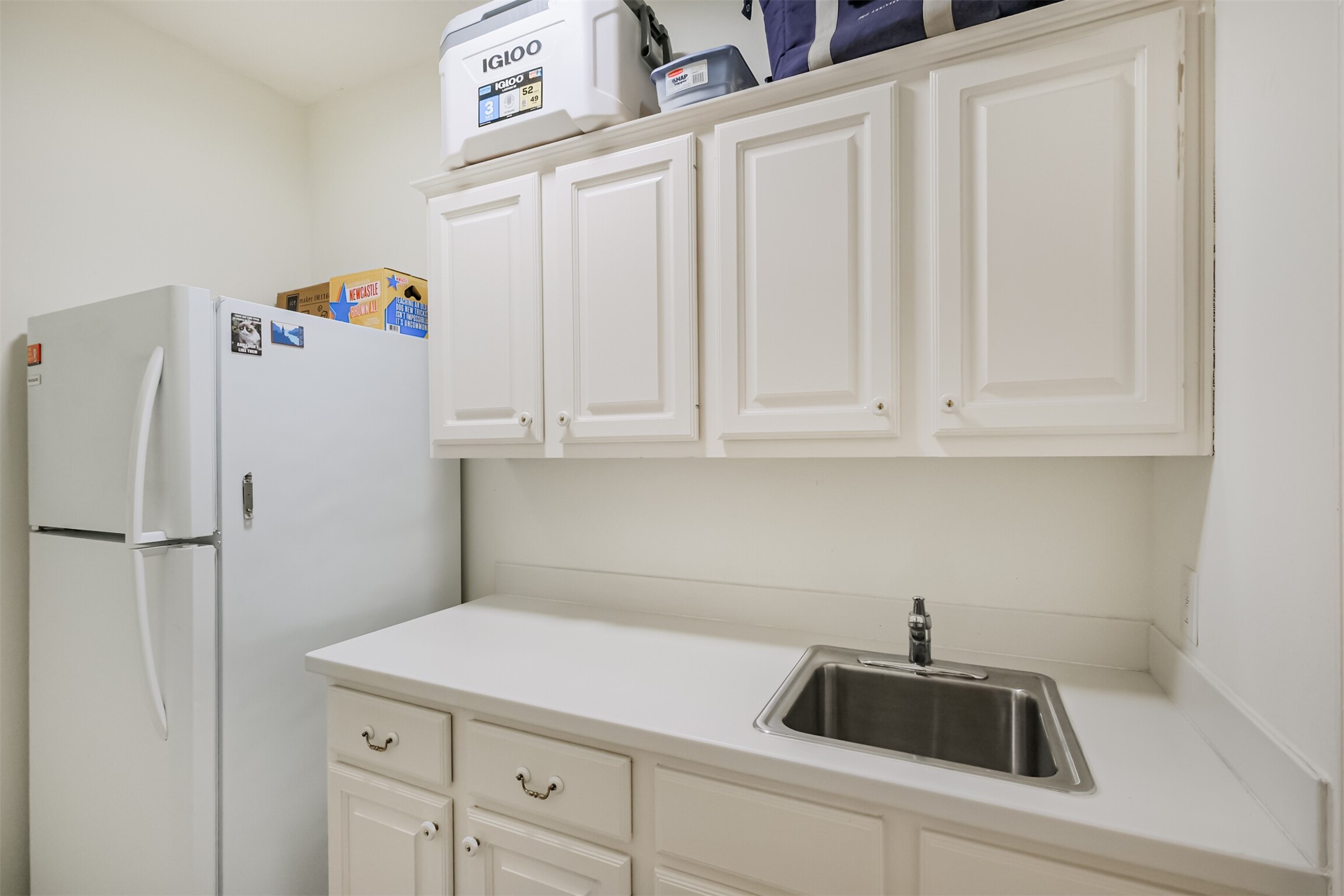 14919 Codys Run Cypress, TX 77429 - Photo 24 of 32 The utility room has room for both a secondary refrigerator and has a utility sink. Plenty of cabinetry!