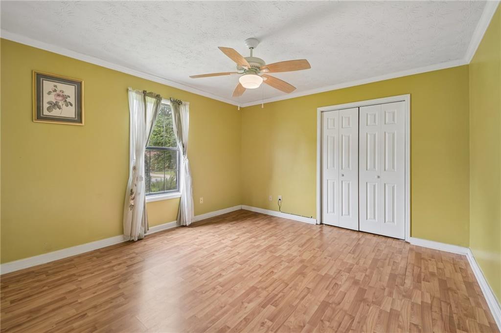 1318 Panhandle Way Hampton, GA 30228 - Photo 12 of 22 an empty room with wooden floor fan and windows