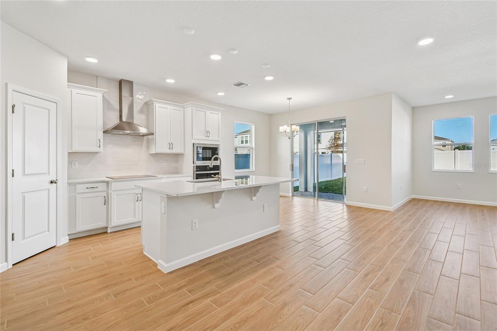 813 River Stone Trail Sanford, FL 32771 - Photo 11 of 33 a large kitchen with stainless steel appliances granite countertop a large counter top a sink and a stove
