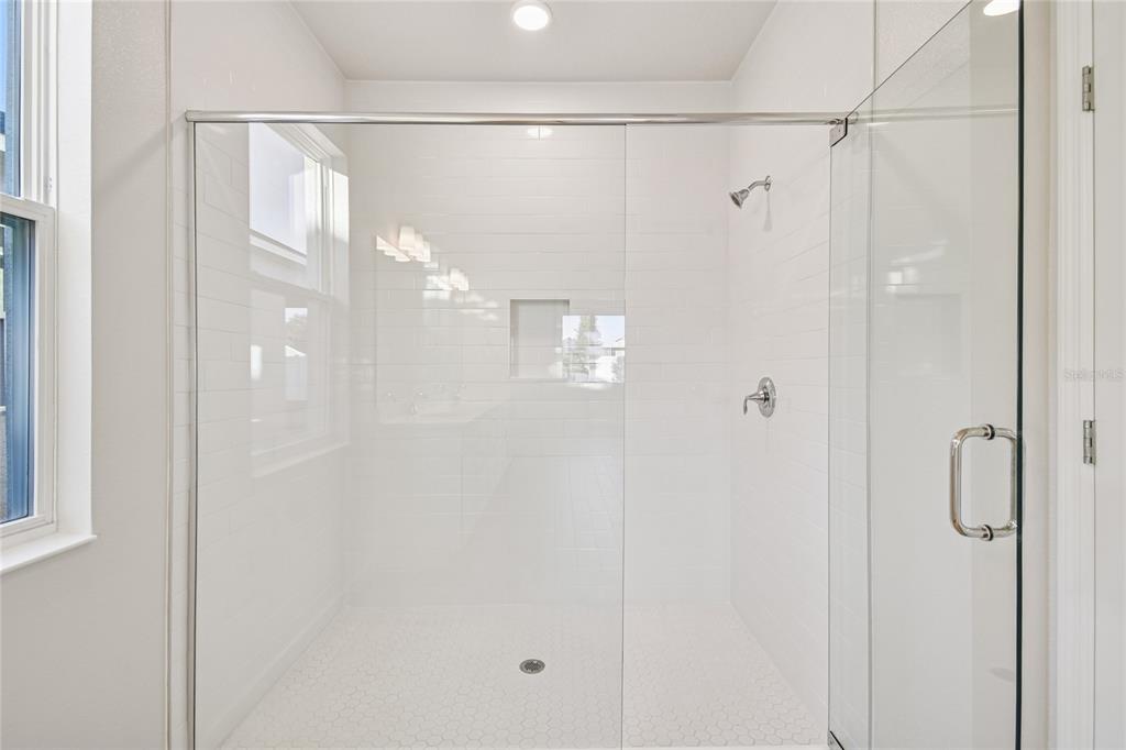 813 River Stone Trail Sanford, FL 32771 - Photo 15 of 33 a bathroom with a glass shower door