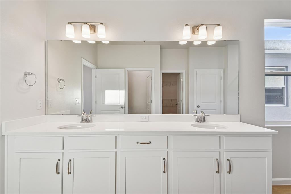813 River Stone Trail Sanford, FL 32771 - Photo 16 of 33 a bathroom with a sink vanity and a mirror