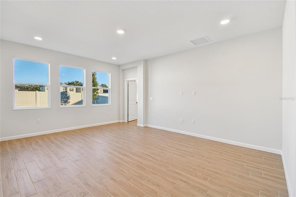 813 River Stone Trail Sanford, FL 32771 - Photo 24 of 33 wooden floor in an empty room with a window