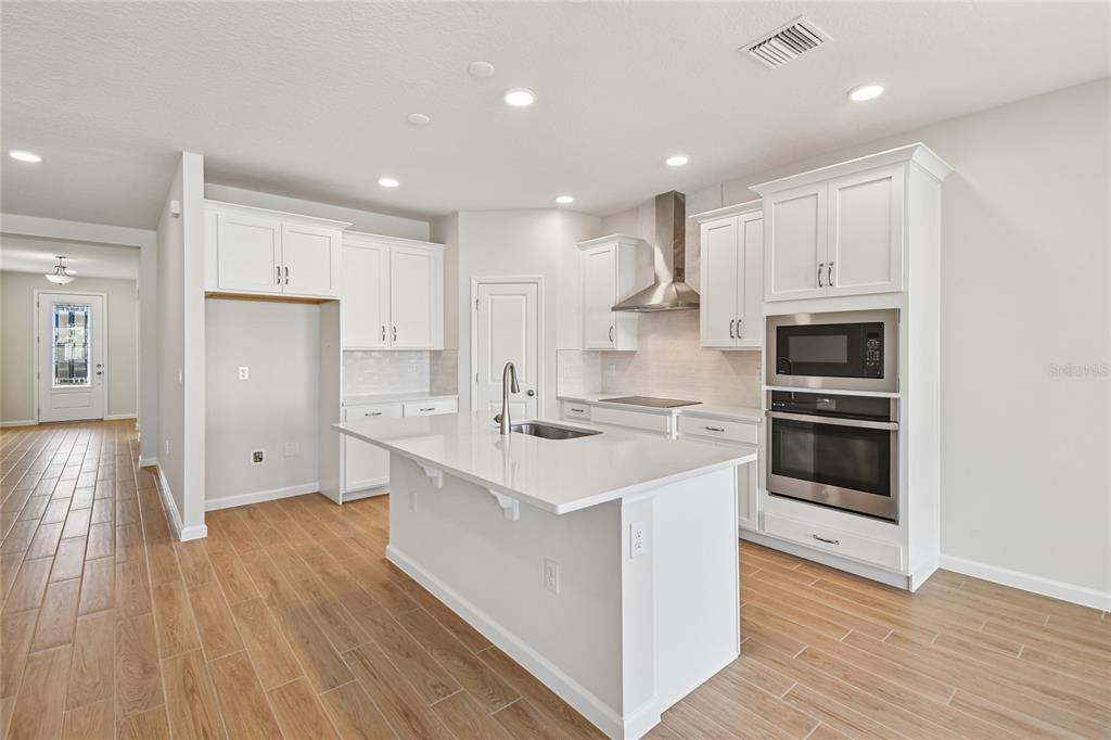 813 River Stone Trail Sanford, FL 32771 - Photo 5 of 33 a kitchen with a sink stainless steel appliances and cabinets