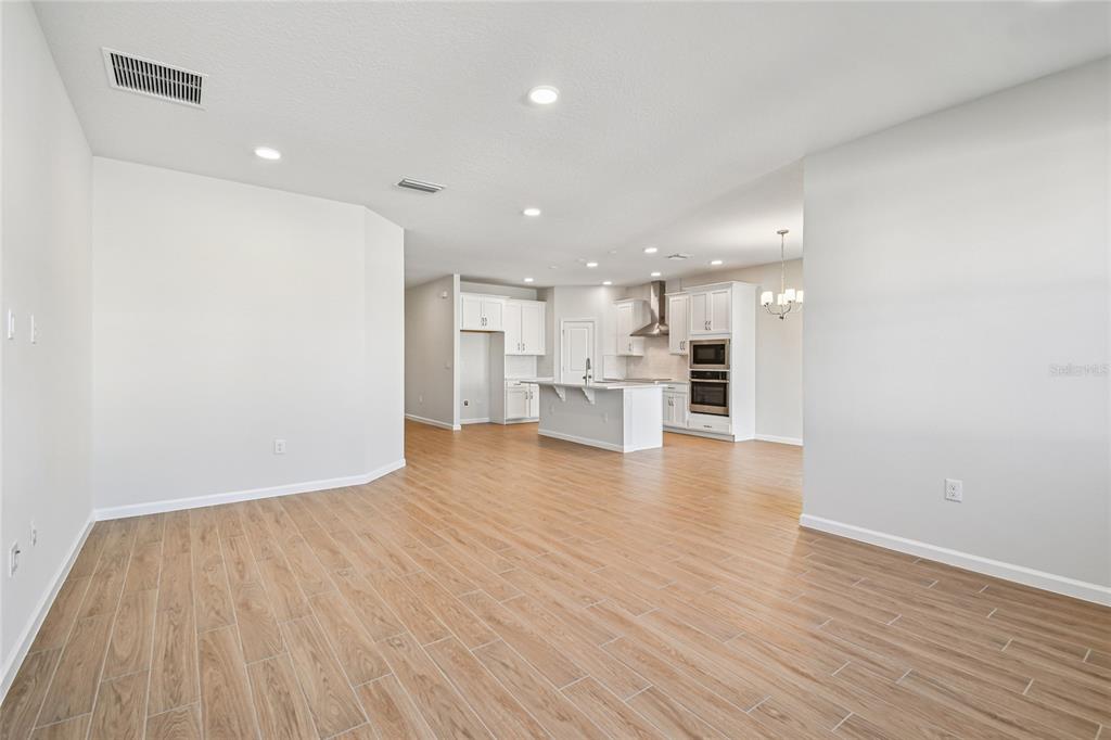 813 River Stone Trail Sanford, FL 32771 - Photo 7 of 33 a view of kitchen and wooden floor