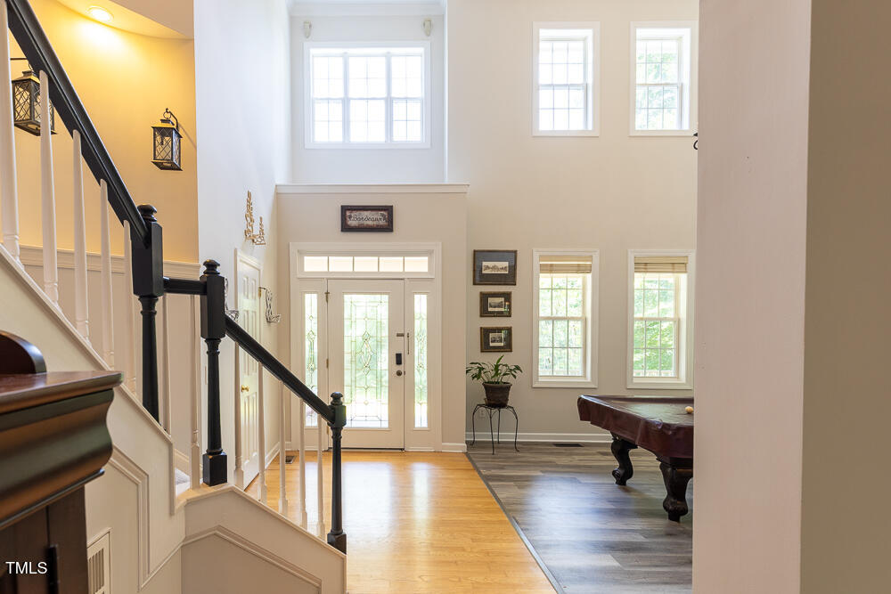5240 Indigo Moon Way Raleigh, NC 27613 - Photo 31 of 74 a view of an entryway with wooden floor and stairs
