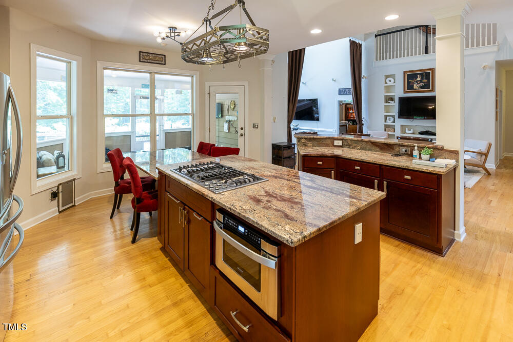 5240 Indigo Moon Way Raleigh, NC 27613 - Photo 6 of 74 a kitchen with stainless steel appliances granite countertop stove a sink and a refrigerator