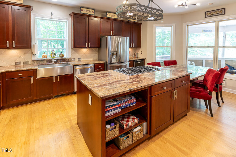 5240 Indigo Moon Way Raleigh, NC 27613 - Photo 7 of 74 a kitchen with stainless steel appliances granite countertop a sink counter space and a window