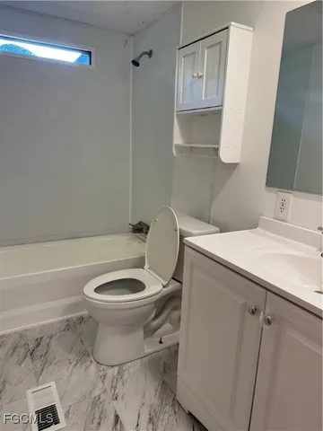 a bathroom with a toilet a sink and bathtub