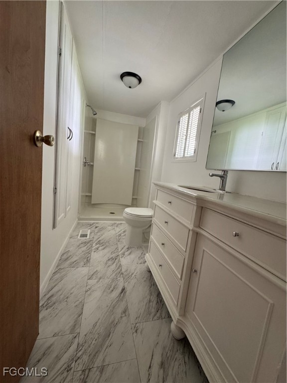 734 Midstate Loop Clewiston, FL 33440 - Photo 22 of 25 a spacious bathroom with a sink mirror vanity and toilet