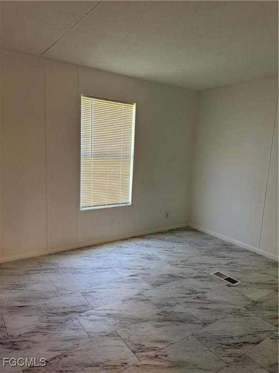 734 Midstate Loop Clewiston, FL 33440 - Photo 23 of 25 a view of an empty room with wooden floor and a window