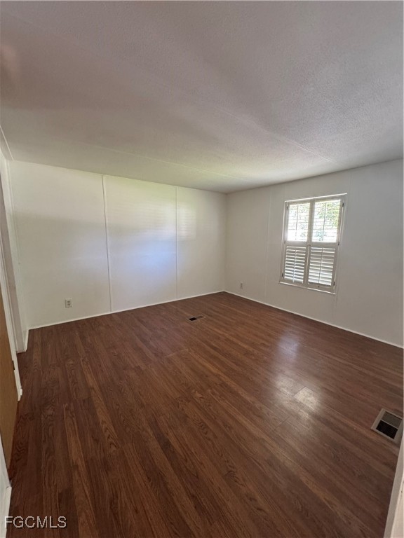 734 Midstate Loop Clewiston, FL 33440 - Photo 24 of 25 an empty room with wooden floor and windows