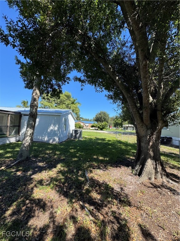 734 Midstate Loop Clewiston, FL 33440 - Photo 6 of 25 a view of a tree in a yard with plants and a large tree