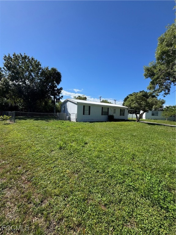 734 Midstate Loop Clewiston, FL 33440 - Photo 10 of 25 a view of a green field with wooden fence