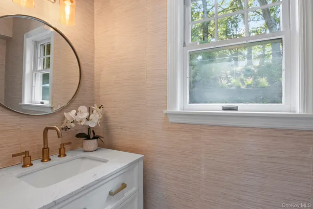 a dining room with furniture a rug and a floor to ceiling window