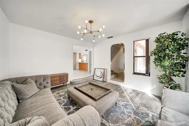 a view of empty room with wooden floor and floor to ceiling window
