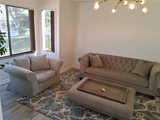 a living room with furniture and a rug