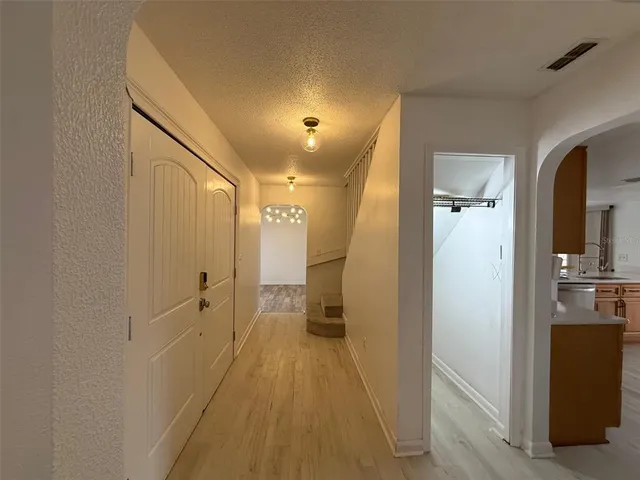 an empty room with a ceiling fan and wooden floor