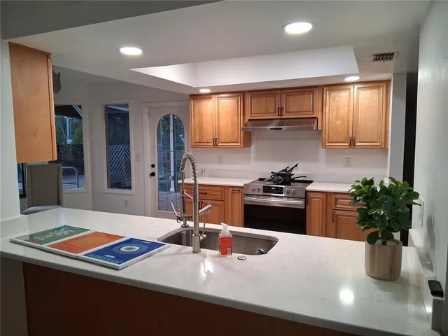 a kitchen with a sink appliances and cabinets