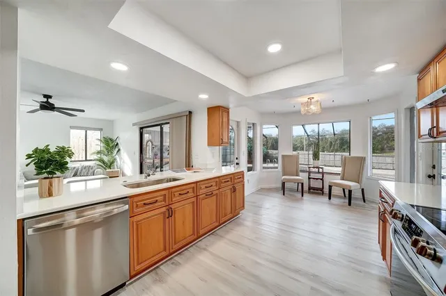 a spacious bedroom with a bed a dresser and wooden floor